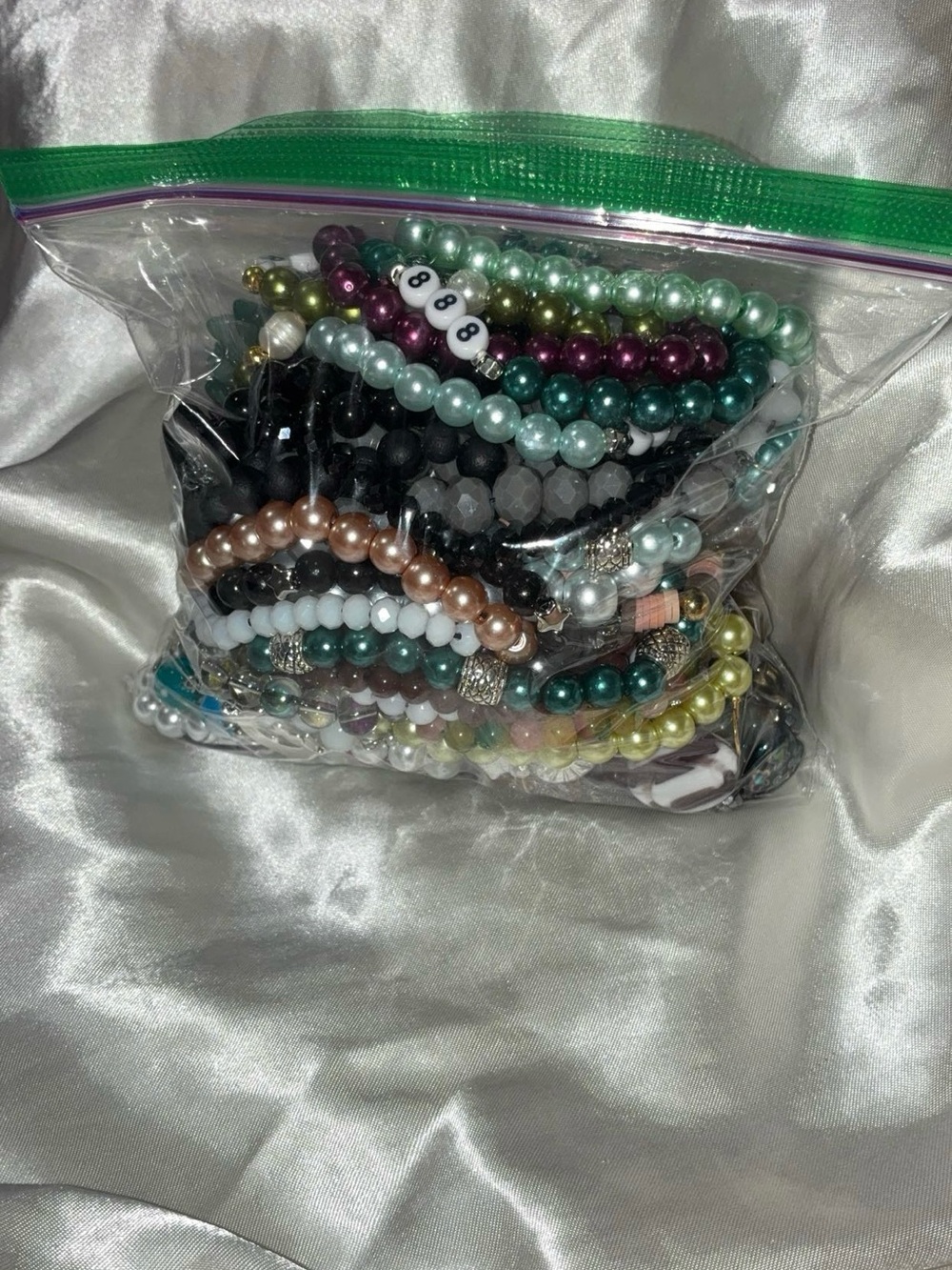 Handmade jewelry lot including bracelets, necklaces, earrings, keychains